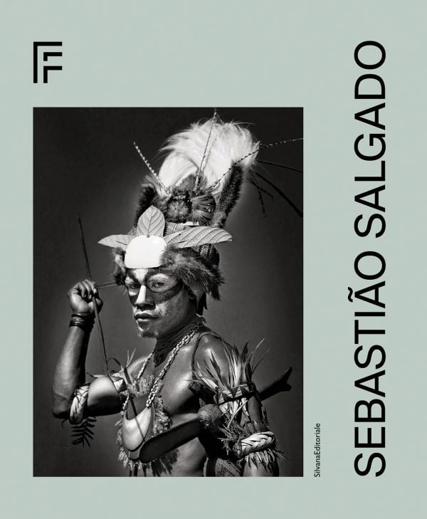 Book cover of Sebastião Salgado featuring a tribesman in traditional dress and face paint. Published by Silvana.