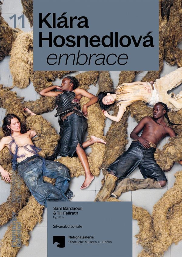 Book cover of Klára Hosnedlová: embrace; featuring a large installation with figures laying on floor surrounded by material sculptures. Published by Silvana.