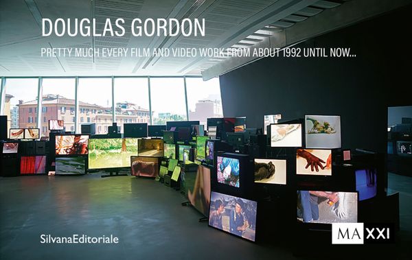 Book cover of Douglas Gordon: Pretty much every film and video work from about 1992 until now...; featuring multiple television screens displaying various video works in a large gallery space. Published by Silvana.