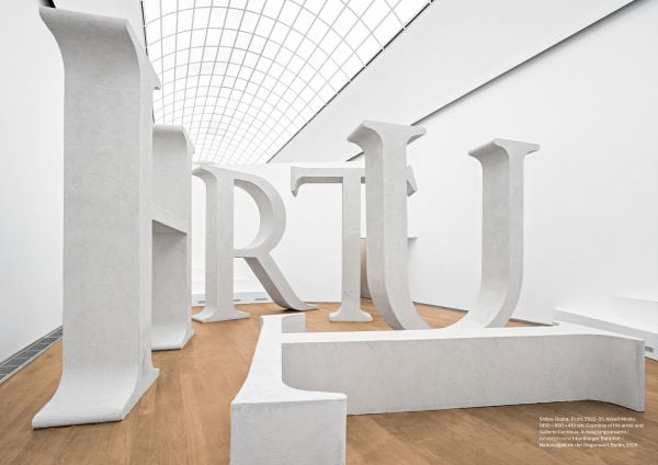 Book cover of Shilpa Gupta: What Still Holds; featuring a person standing among an installation of large white letters. Published by Silvana.