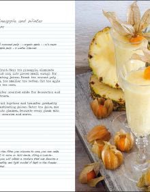 Book cover of Cold-Pressed Beverages, Health and Well-Being in a Glass, with dark red smoothies in white mugs with cocktail sticks of blueberries. Published by White Star.