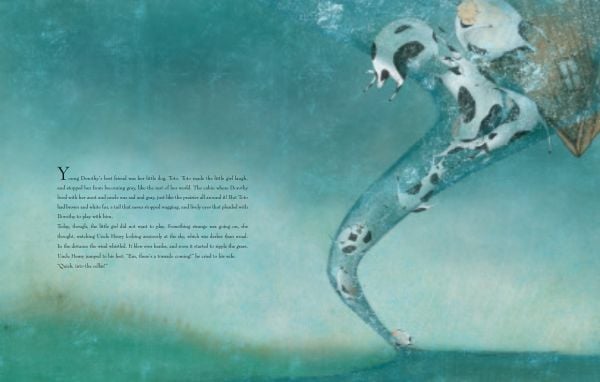 Book cover of The Wizard of Oz, Based on the Masterpiece by L. Frank Baum, with Tinman holding his heart, and Dorothy holding his arm. Published by White Star.