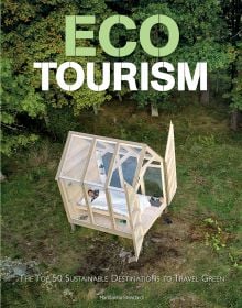 Aerial view of small, wooden framed glass house, with person inside sleeping in bed, on cover of 'Ecotourism, The Top Sustainable Destinations to Travel Green', by White Star.