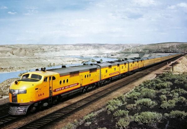 Book cover of Trains, From Steam Locomotives to the Future of Sustainability, with a Dreyfuss styled J-3a Hudson locomotive. Published by White Star.