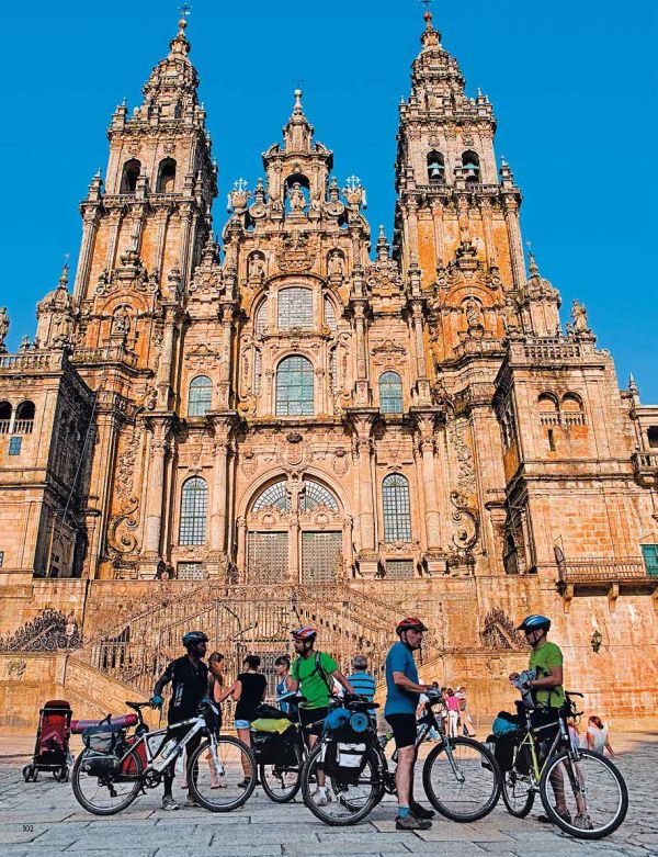 Book cover of Let's Bike!, The Best European Routes on Two Wheel, with a man standing with a pushbike looking towards a sunny mountain view. Published by White Star.