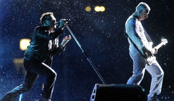 Book cover of U2, Past Present Future, with an early promo shot of band in leather jackets. Published by White Star.