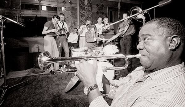 Book cover of Legends of Jazz, with the outline of a tenor saxophone. Published by White Star.