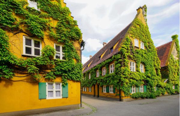 Industrial landscape with tall chimneys on cover of 'Architecture at Work, Towns and Landscapes of Industrial Heritage', by Forma Edizioni.