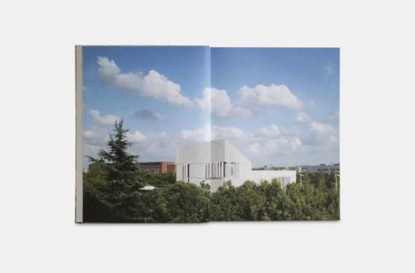 Modern architectural building with patterned surface and green trees below, on cover of 'Green Energy Laboratory, Archea Associati', by Forma Edizioni.