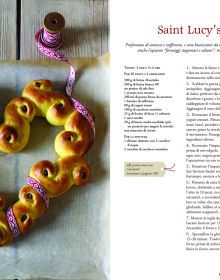 Christmas chocolate roulade, sprinkled with icing sugar, on glass dish, on cover of 'Christmas at Last! Holiday Recipes and Stories from Italy', by Guido Tommasi Editore.