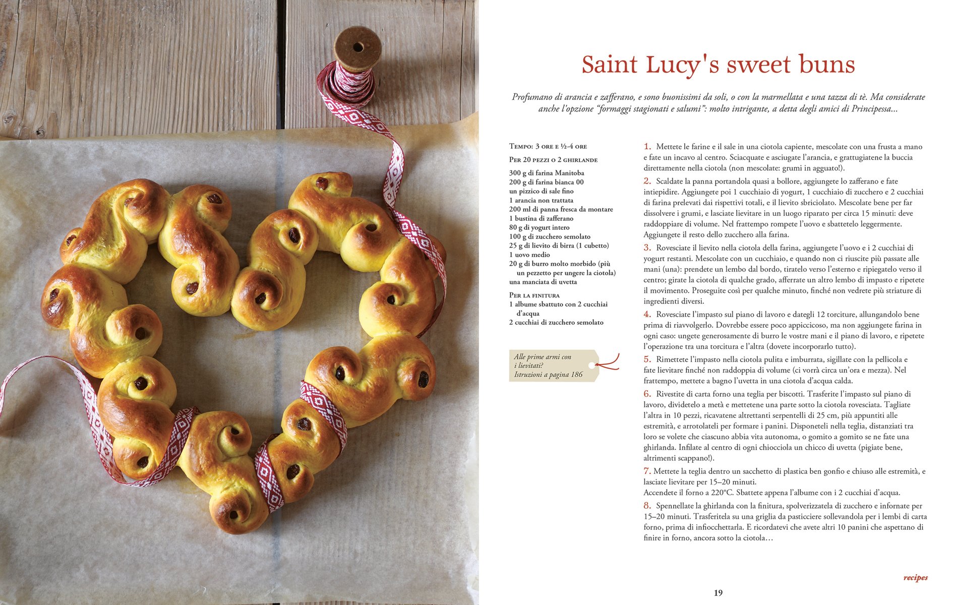 Christmas chocolate roulade, sprinkled with icing sugar, on glass dish, on cover of 'Christmas at Last! Holiday Recipes and Stories from Italy', by Guido Tommasi Editore.