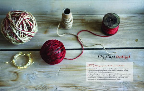 Christmas chocolate roulade, sprinkled with icing sugar, on glass dish, on cover of 'Christmas at Last! Holiday Recipes and Stories from Italy', by Guido Tommasi Editore.