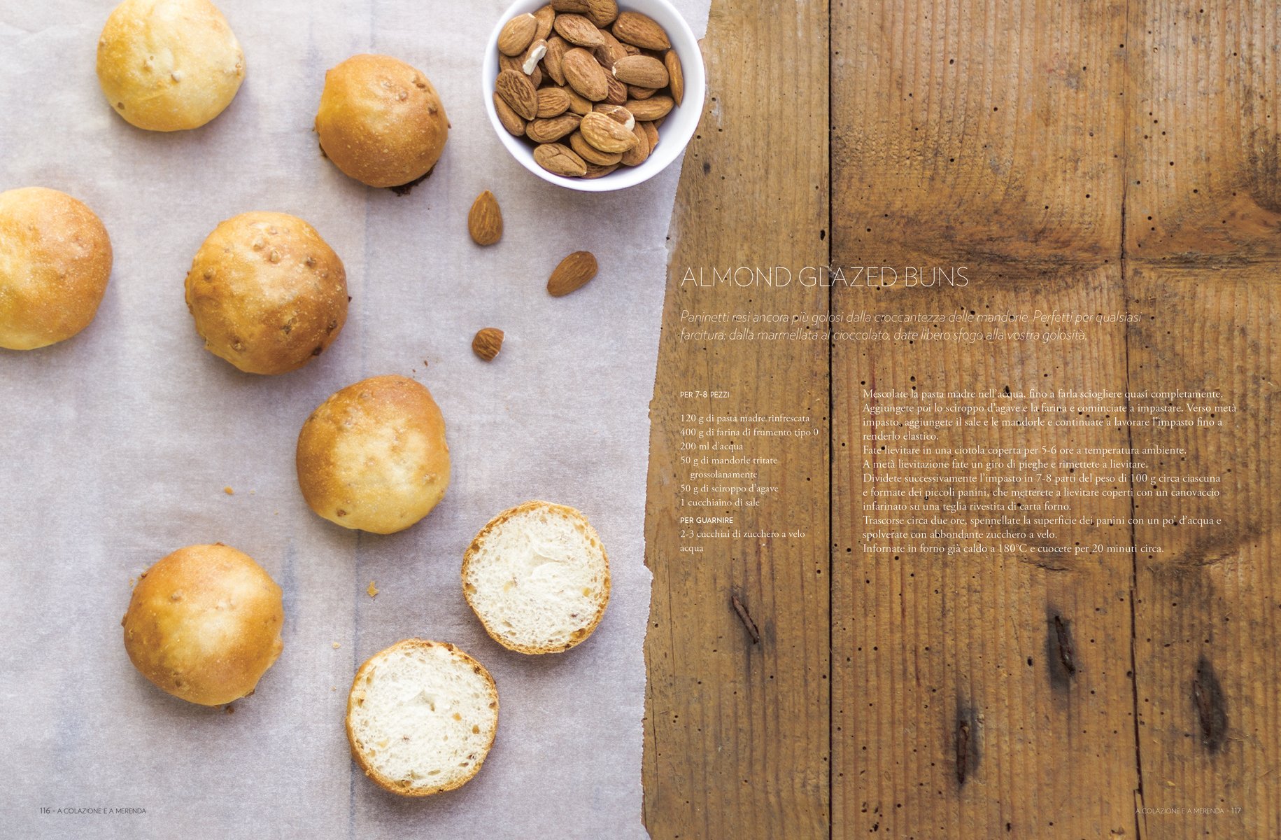 Large round brown top sourdough bread, dusted with flour, on wood board, on cover of 'Sourdough, A Complete Guide and Recipe Book', by Guido Tommasi Editore.