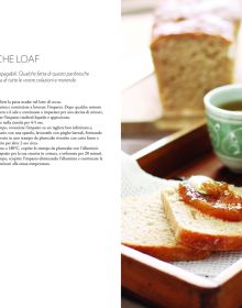 Large round brown top sourdough bread, dusted with flour, on wood board, on cover of 'Sourdough, A Complete Guide and Recipe Book', by Guido Tommasi Editore.