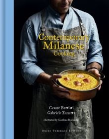 Chef in gray apron holding copper pan will yellow food, on cover of 'Contemporary Milanese Cooking', by Guido Tommasi Editore.