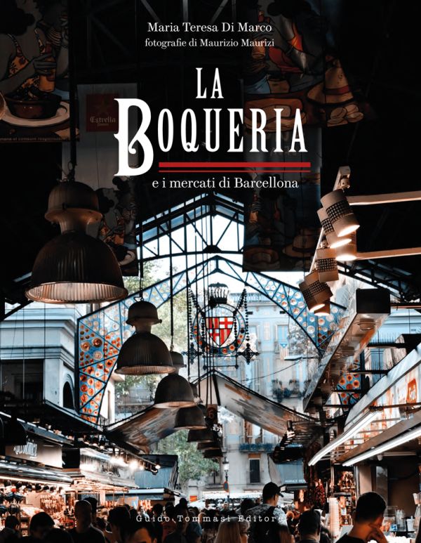 Book cover of The Boqueria, with Barcelona's La Boqueria food market, with large lights hanging from ceiling above crowds of shoppers and tourists. Published by Guido Tommasi Editore.