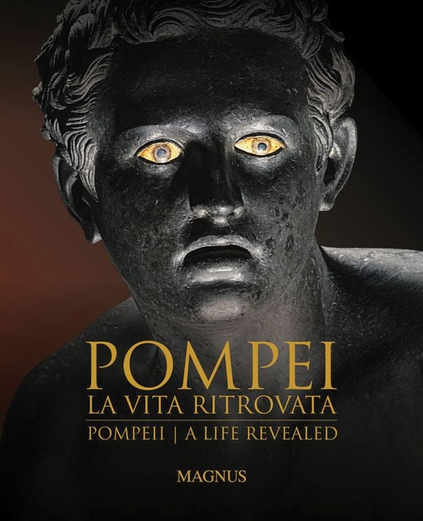 Book cover of Pompeii: A Life Revealed, featuring a bronze head with mouth open, and bright yellowing eyes. Published Scripta Maneant Editori.