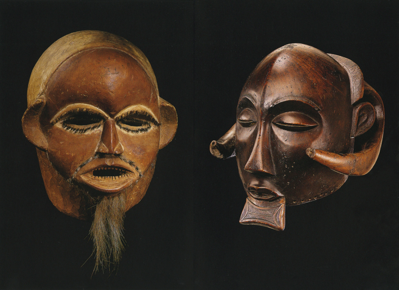 Dark wood carved mask with horn ears, black cover, VISIONS OF AFRICA LUBA in black font on top white banner.