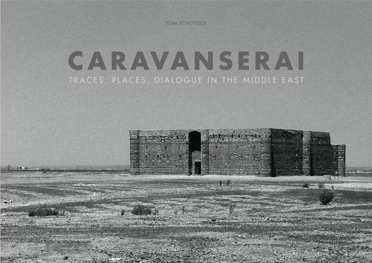 Landscape book cover of Caravanserai, Traces, Places, Dialogue in the Middle East, featuring a black and white photo of large, flat-roofed building in Middle Eastern landscape. Published by 5 Continents Editions.