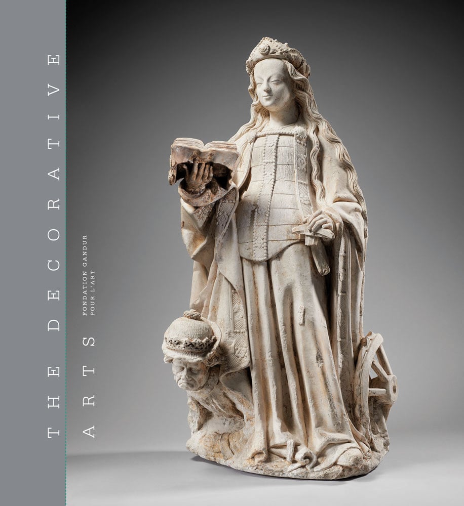 Book cover of The Decorative Arts, Volume 1: Sculptures, enamels, maiolicas and tapestries, featuring a cream statue of woman in large dress, holding book in right hand. Published by 5 Continents Editions.