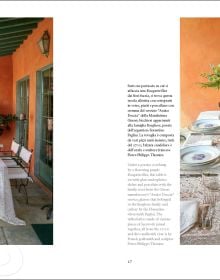 Book cover of Dining in Style: Between the Traditional and the Contemporary, featuring a classical dining table with crystal glasses and floral, porcelain plates. Published by Mandragora.