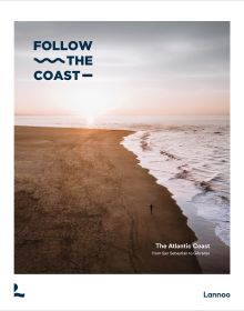 Book cover of Follow the Coast – from San Sebastián to Gibraltar: A Visual Travel Guide of the Atlantic Coast, featuring an aerial beach view. Published by Lannoo Publishers.