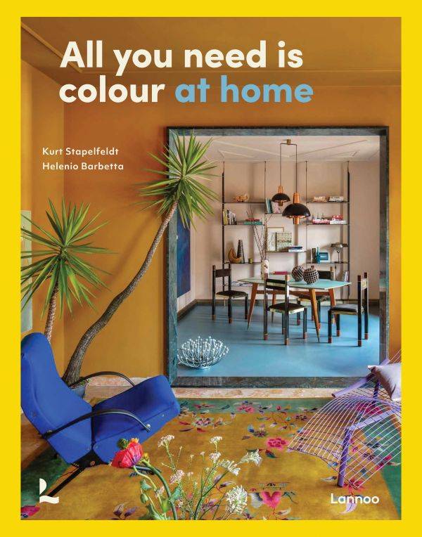 Book cover of All You Need is Colour: At Home; featuring a living room with floral rug, large mirror and tropical plant. Published by Lannoo Publishers.