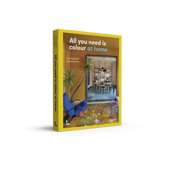 Book cover of All You Need is Colour: At Home; featuring a living room with floral rug, large mirror and tropical plant. Published by Lannoo Publishers.