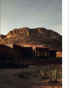 Book cover of The World’s Best Nature & Design Hotels; featuring a modern desert hotel with outdoor loungers. Published by Lannoo Publishers.