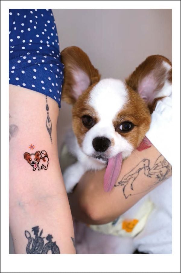 Book cover of Happy Tattoos: The Best Fun-Loving Tattoo Artists; featuring three tattoos: a dinosaur on a skateboard, a penguin with a bow on its head, and a dragon shouting through megaphone. Published by Lannoo Publishers.