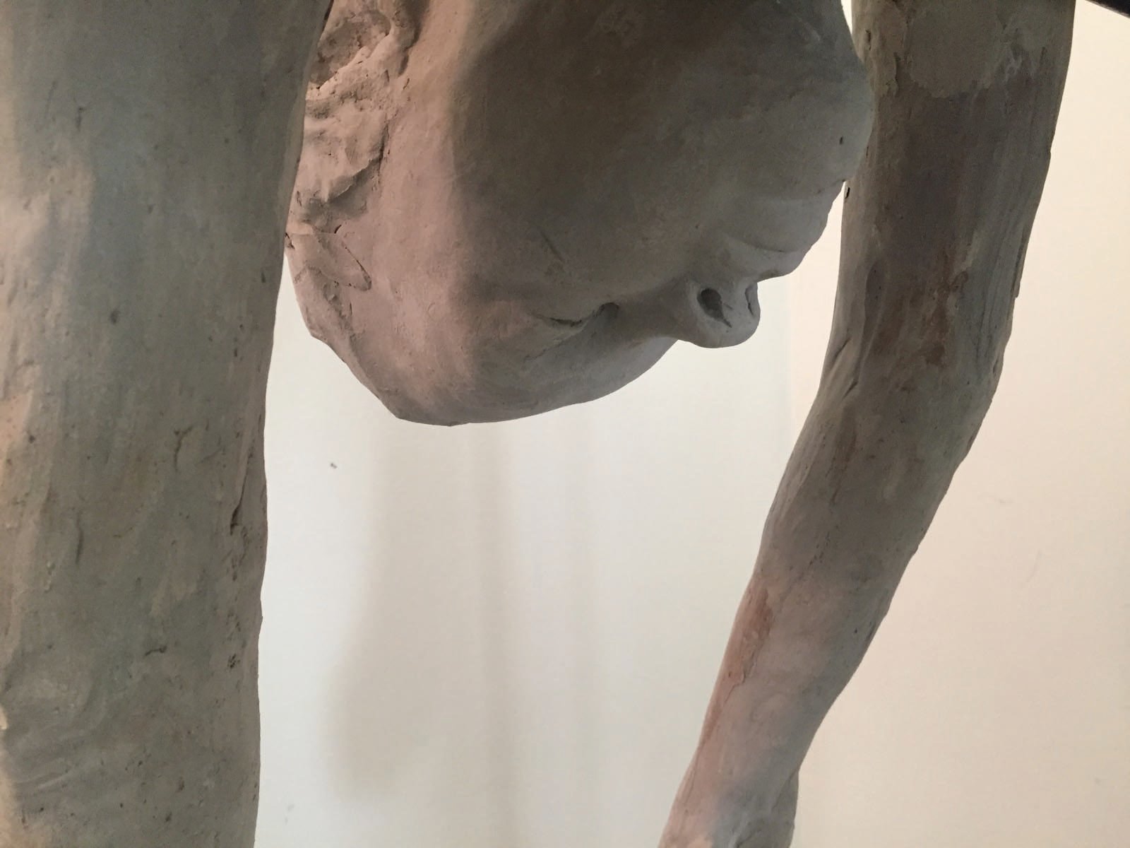 Life sized clay sculpture of girl sitting on bed, Breath in pale grey font above