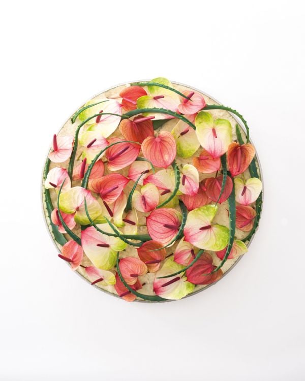 Black book cover of Koji Arai's The Eternal Flower, with a circular floral design of blue and purple flowers; clematis, hydrangea, orchid. Published by Stichting.