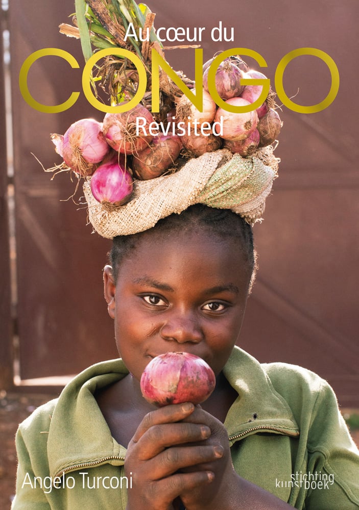 African girl holding red onion to lips, bunch of onions resting on head, CONGO Revisited in gold and white font above
