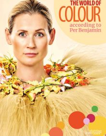 Book cover of The World of Colour According to Per Benjamin, with a model wearing a ring of pink and yellow lilies around neck, with long thin feathers spraying out. Published by Stichting.