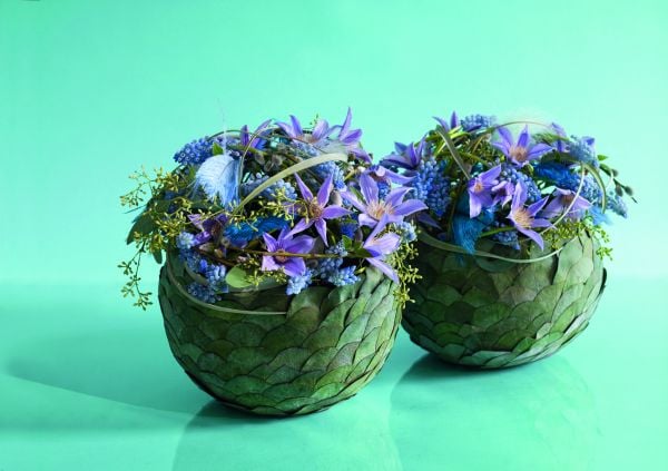 Book cover of The World of Colour According to Per Benjamin, with a model wearing a ring of pink and yellow lilies around neck, with long thin feathers spraying out. Published by Stichting.