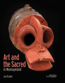 Black book cover of Jan Strybol's Art and the Sacred in Mumuyeland, featuring a carved wood head with large holes for eyes and blunt beak. Published by Stichting.