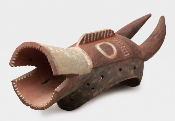 Black book cover of Jan Strybol's Art and the Sacred in Mumuyeland, featuring a carved wood head with large holes for eyes and blunt beak. Published by Stichting.