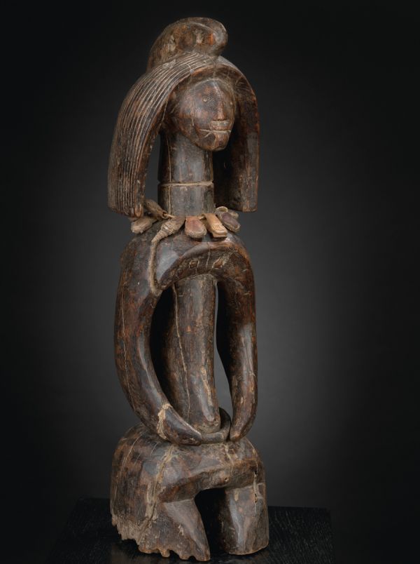 Black book cover of Jan Strybol's Art and the Sacred in Mumuyeland, featuring a carved wood head with large holes for eyes and blunt beak. Published by Stichting.