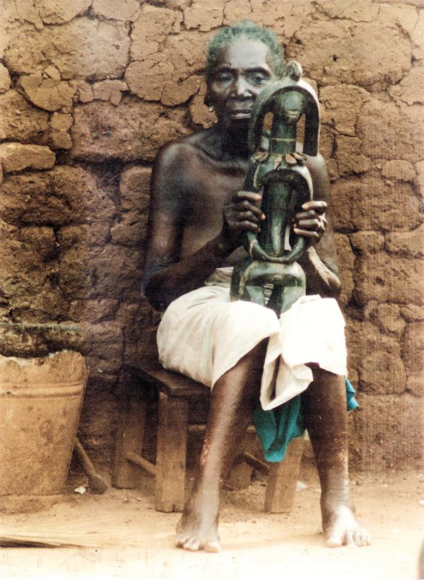 Black book cover of Jan Strybol's Art and the Sacred in Mumuyeland, featuring a carved wood head with large holes for eyes and blunt beak. Published by Stichting.