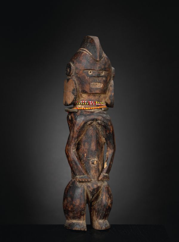 Black book cover of Jan Strybol's Art and the Sacred in Mumuyeland, featuring a carved wood head with large holes for eyes and blunt beak. Published by Stichting.