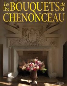 Book cover of The Bouquets of Chenonceau, featuring a bouquet of flowers in a large urn with base, in front of decorative fireplace. Published by Stichting.