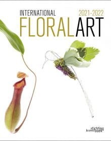 White book cover of International Floral Art 2021/2022, with carnivorous monkey cup plant and foliage made into hummingbird. Published by Stichting.