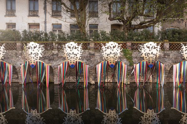 Book cover of Bruges Triennial 2021, TraumA, with a red skeletal platform structure surrounded by green trees. Published by Stichting.