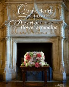 Book cover of The Art of Flower Arranging, Château de Chaumont-sur-Loire featuring a large ornate fireplace with pink, green and white floral arrangement on small dark wood table below. Published by Stichting.