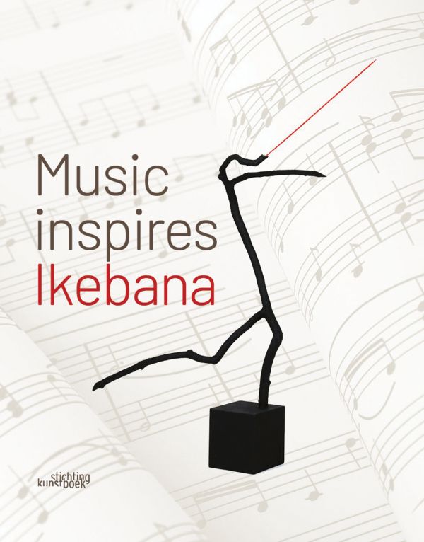 Book cover of Music Inspires Ikebana, with a tree branch shape with a conductors baton fixed to one end. Published by Stichting Kunstboek.