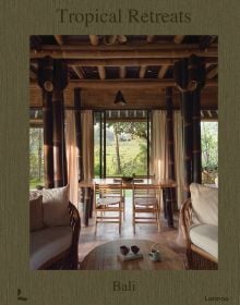 Book cover of Tropical Retreats; featuring an interior living space with wood furniture and bamboo beams. Published by Lannoo Publishers.