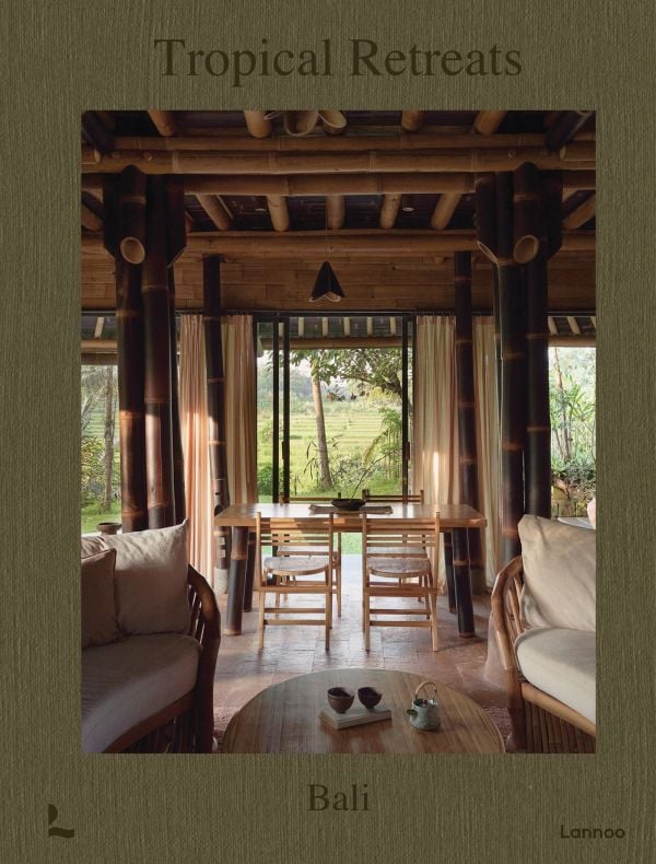 Book cover of Tropical Retreats; featuring an interior living space with wood furniture and bamboo beams. Published by Lannoo Publishers.