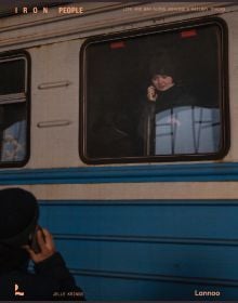 Book cover of Iron People: Life and War Along Ukraine’s Railway Tracks; with person on a mobile phone, looking out of a train window. Published by Lannoo Publishers.