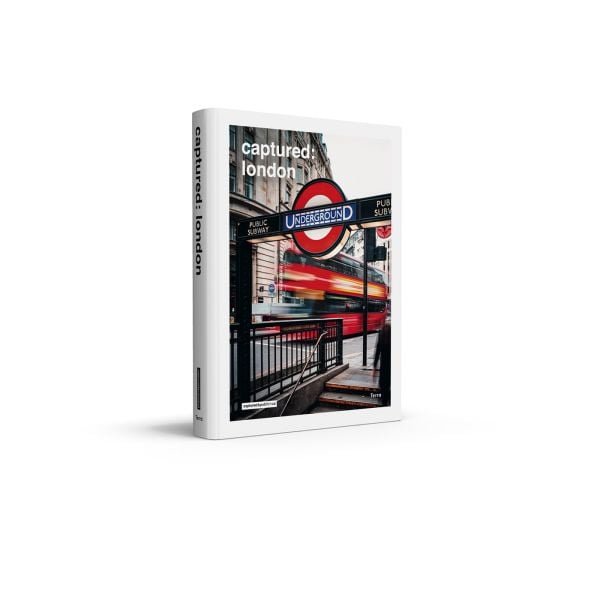 Book cover of Captured: London; with a neon underground sign to entrance with red bus behind. Published by Lannoo Publishers.
