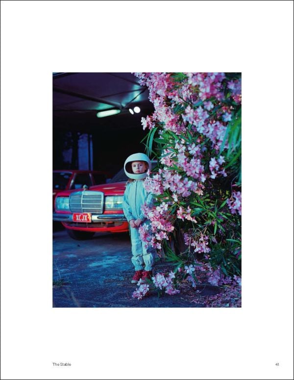Book cover of The Rocketgirl Chronicles; with a child dress in home made space suit and helmet, sitting on a chair with a radio. Published by Lannoo Publishers.
